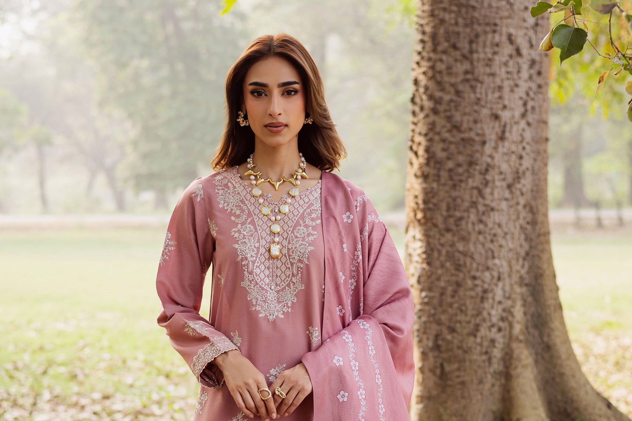 Woman in a pink traditional outfit with embroidery